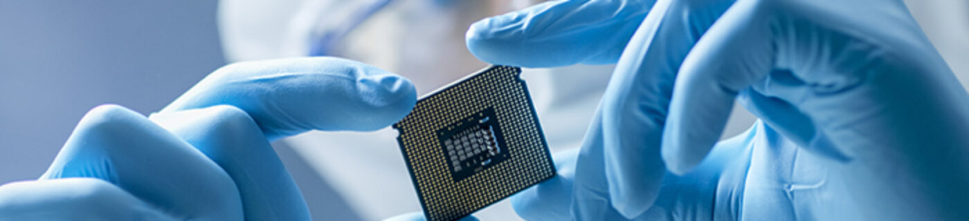 Mercury scientist holding up a semiconductor chip